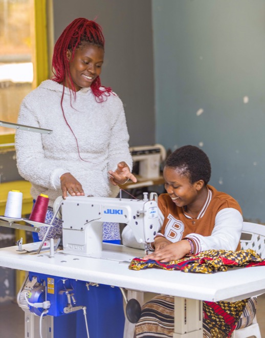 Two women sewing together