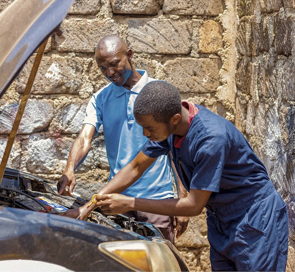 Student learning how to fix car
