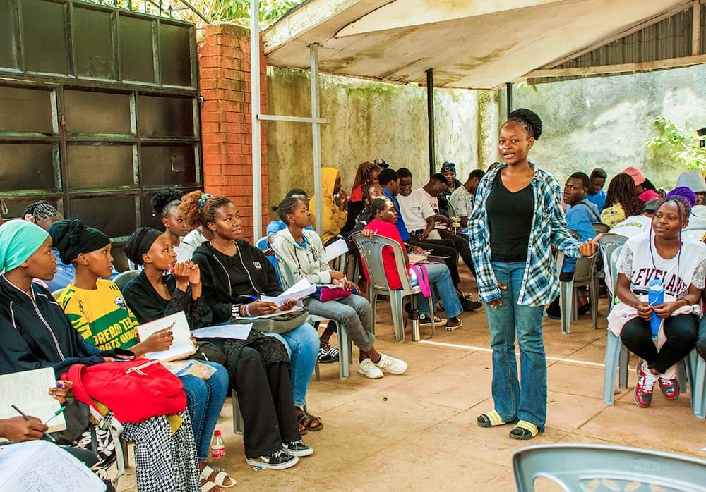 Student presenting her work at an exhibition.