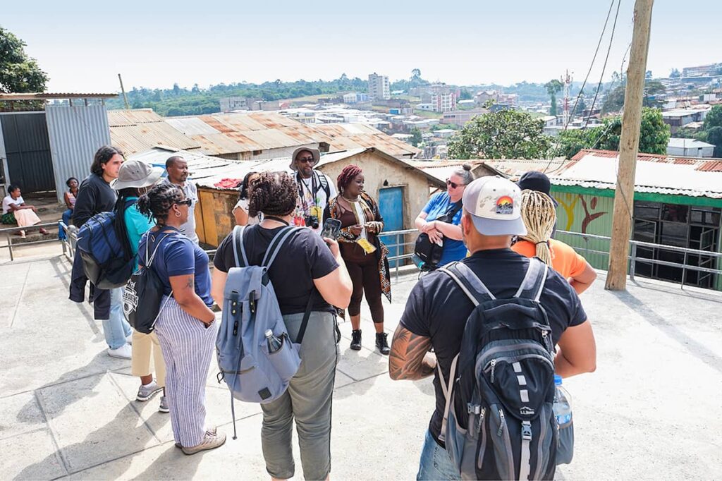 Group of visitors on rooftop looking over Nairobi.